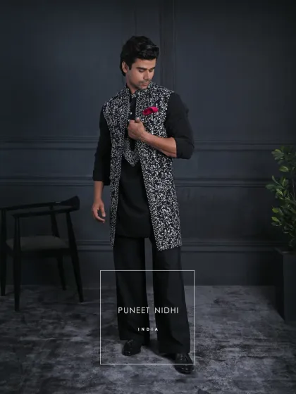 The full-length look of the black and white open-style Achkan, showing how it pairs with tailored trousers for a sharp, festive look.
