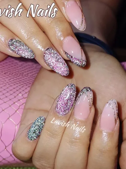 A multi-tonal glitter design on almond nails, creating a sparkling and dynamic effect.