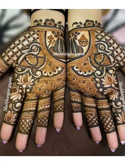 A festive design for Lohri, featuring peacocks and kalash motifs. The patterns are not mirrored, giving each hand a unique look while still feeling connected.