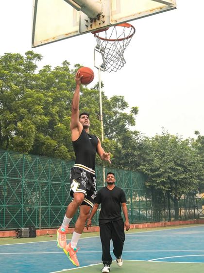 A dream does not become reality through magic; it takes sweat, determination and hard work. A player soars for a layup.