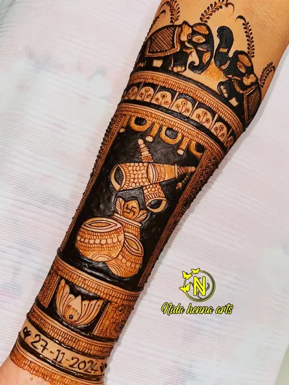 This bridal arm design incorporates traditional wedding symbols like the shehnai and kalash. I also personalized it by adding the wedding date, 27-11-2024, as a lasting memory.