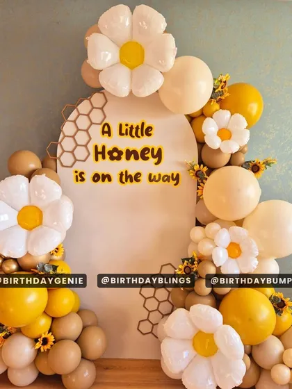 For this "A Little Honey is on the way" baby shower, I designed a sweet and charming backdrop. The decor features a honeycomb-patterned panel, adorable daisy-shaped balloons, and a warm color palette of yellow, white, and tan to celebrate the upcoming arrival.