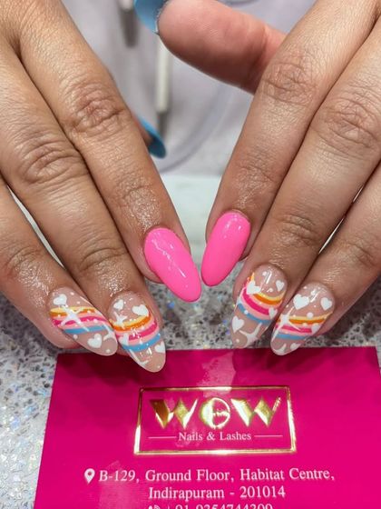A bright and cheerful rainbow design. This look features a sheer base with colorful stripes and hearts, perfect for spreading joy.