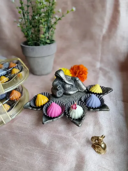 During Ganesh Chaturthi, I offer these handcrafted chocolate modaks in a vibrant array of colors and flavors. This festive box showcases a variety including mango, strawberry, and pista, making for a beautiful and modern prasad offering.