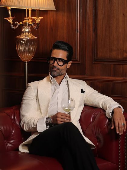 A relaxed moment in our white textured tuxedo jacket, showcasing its refined yet comfortable fit.