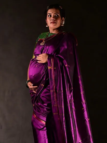 A full-length portrait from the traditional maternity shoot. The makeup, hair, and saree drape all come together to create a look of timeless grace.