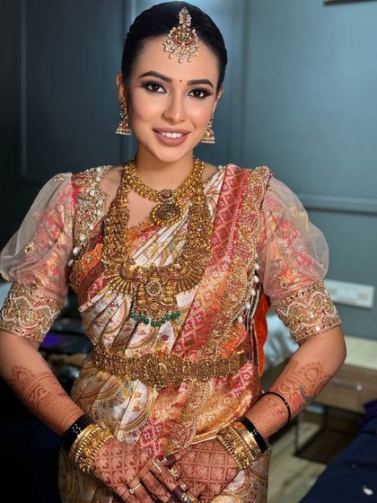 A happy, smiling portrait of the bride, looking radiant and confident on her special day.