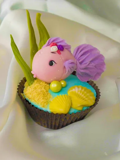 A whimsical fish topper with detailed fins and expressive eyes. These quick sessions are perfect for learning the fundamentals of fondant modeling.