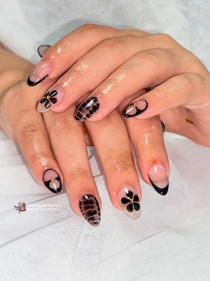 This image showcases the full set, demonstrating how different designs on each nail can create a cohesive and sophisticated look.