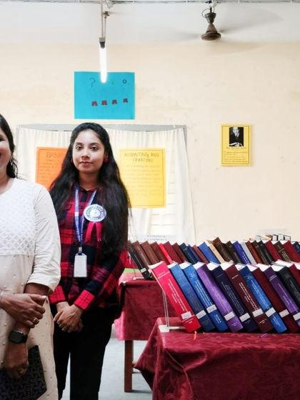 Posing with a student by a display of theses at the University of Kerala. The entire campus was alive with the spirit of research and celebration.