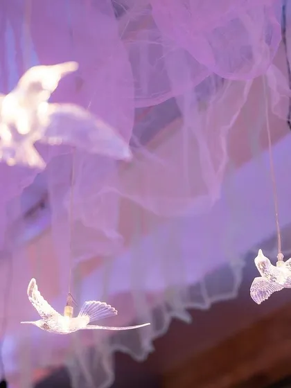 Another shot of the glowing bird props, which looked like they were flying through the draped ceiling.