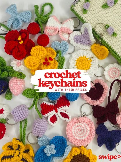 Here's a big flat lay of all the different floral and character keychains I offer. You can see everything from butterflies and daisies to strawberries and cherries.