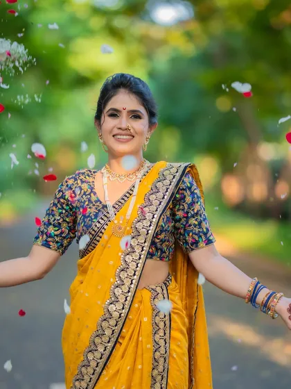 A shower of petals for a joyous bride. Her makeup is fresh and radiant, perfect for these candid, happy moments.