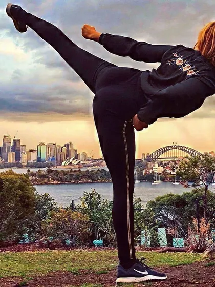 Strength against a city skyline. This image captures the idea that the skills you learn with us can empower you anywhere in the world.