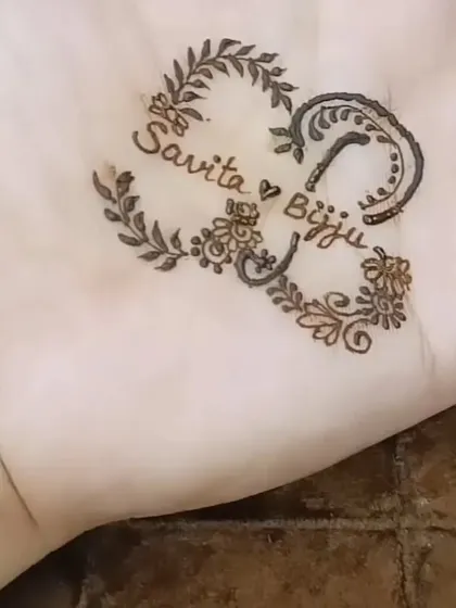 I love adding a personal touch to my designs. Here is an example of a custom heart-shaped design incorporating the couple's names, "Savita" and "Bijju," woven into the pattern.