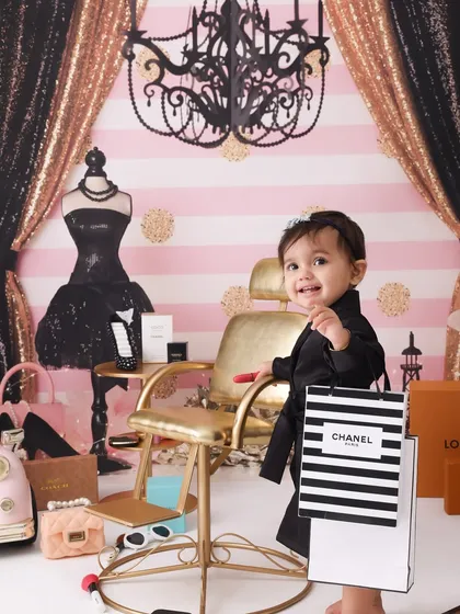 Shopping spree! This little one is ready to hit the stores with her Chanel bag. The pink, black, and gold color scheme of this fashion theme is chic, glamorous, and so much fun.