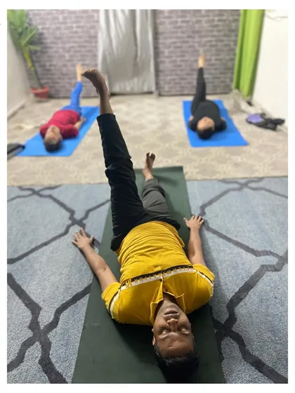Core work is central to our practice. Here, a student engages his core with a leg lift variation, building abdominal strength which is key for stability in all other asanas.