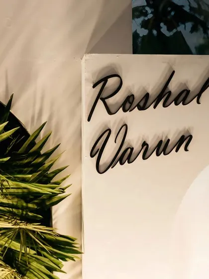 A close-up of the custom signage for Roshal and Varun's wedding. The elegant black script stands out against the clean white backdrop, adding a touch of modern sophistication.