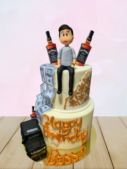A two-tiered cake for the "Boss," featuring edible money, a miniature car, and bottles of Jack Daniel's. It's a fun and extravagant cake for a big celebration.