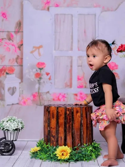 A candid shot filled with expression. The baby's open-mouthed look of wonder or excitement brings so much personality to this photo from the floral-themed session.