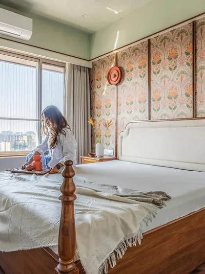 A bedroom should be a personal sanctuary. For this traditional home, we created a feature wall with floral wallpaper framed by wood battens, paired with a classic four-poster bed. The result is a cozy, textural, and timeless space that invites rest.