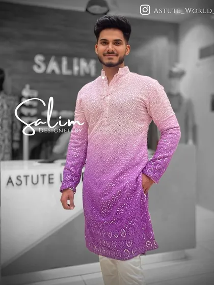A modern kurta with a pink to purple ombre dye effect, embellished with scattered sequins. This is a fun and contemporary choice for a sangeet or mehndi party.