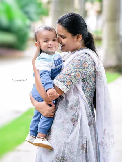 A tender moment between a mother and her baby, sharing a smile. These simple, loving interactions are what make family photos so special.