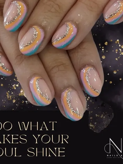 A beautiful, multi-colored design with a soft, pastel palette. The curved stripes are separated by a delicate line of silver glitter, creating a gentle, shimmering effect.