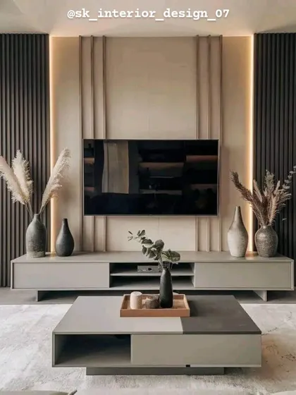 A minimalist TV unit with a neutral color palette and clean lines. The vertical wood paneling and simple console are complemented by dried pampas grass for a natural touch.