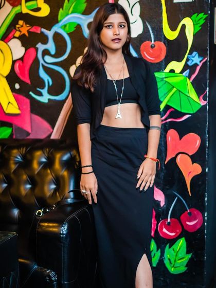 A guest posing against the colorful graffiti wall.