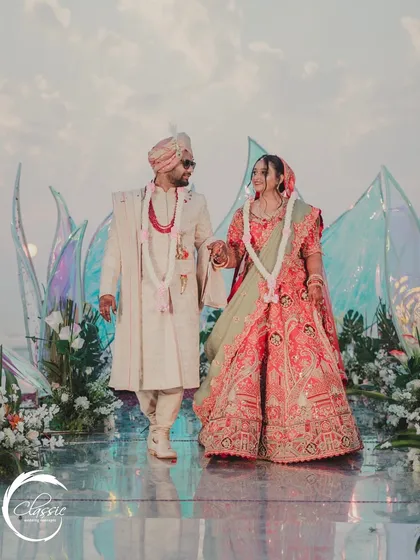 The first steps as husband and wife. The mirrored aisle reflects the sky and the couple, creating a beautiful, symbolic image as they walk away from the unique, modern mandap.