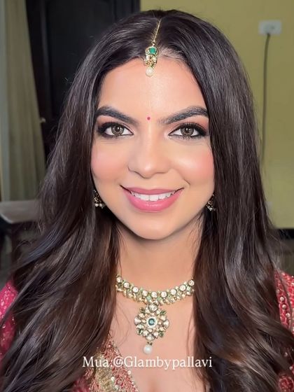 A close-up portrait of Ekta. The pink shimmer on her eyes adds a touch of glamour, while the rest of the makeup is kept fresh and natural.