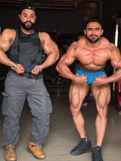 Let's go. Posing with a friend in the gym.