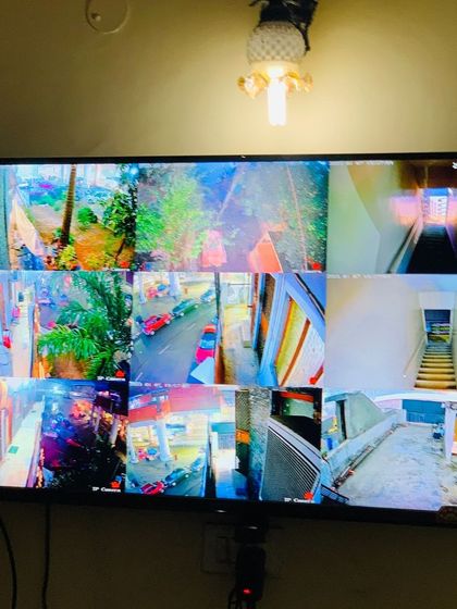 A 9-camera view with bright, clear colors, monitoring multiple floors and outdoor areas.