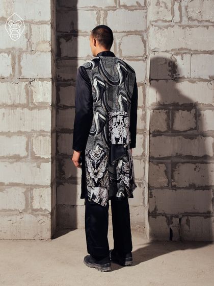 The back view of the Mythic Tapestry kurta, showcasing the continuous flow of symbolic patterns that wrap the garment in a narrative of myth and monochrome.