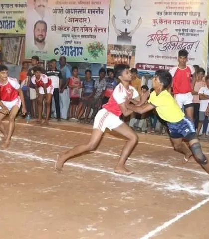 An action shot from a sub-junior match, showing a defender trying to stop a raider.