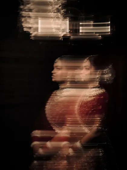 An experimental bridal portrait using a dragging shutter technique to create a ghosting, multi-exposure effect.