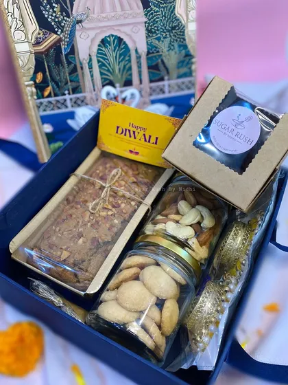 The 'Diwali Delight Box' is a grand gesture, including a tea cake, nut and cookie jars, a brownie box, and festive diyas.