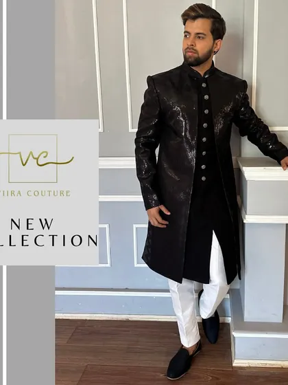 A model wearing our custom black sequined Indo-Western sherwani. The structured shoulders and long silhouette create a powerful and modern ethnic look.