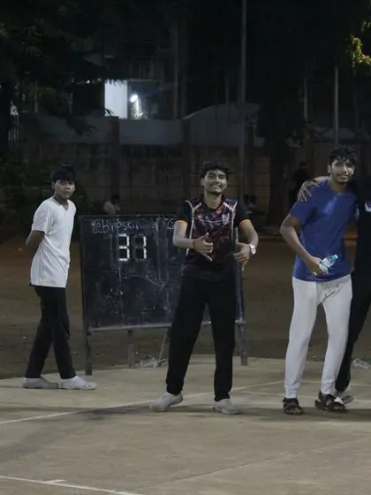 Young players celebrating and having fun on the court after their game.