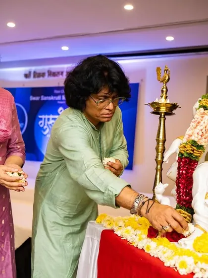 A moment of prayer and gratitude as my wife and I offer flowers to the idol of Goddess Saraswati at the start of Guruvandan. We seek her blessings for a day filled with music and learning.