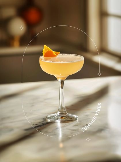 Experience bright, citrusy summer vibes in a glass. This beautifully garnished mocktail, served on a cool marble top, is the perfect antidote to a warm day.