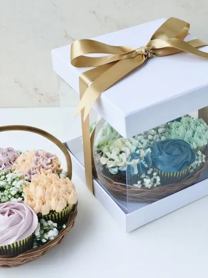 I believe the best gifts are the ones you can eat. My handcrafted floral cupcake baskets are perfect for any celebration, featuring moist Belgian chocolate cupcakes decorated with intricate vanilla buttercream flowers and presented in a beautiful gift box.