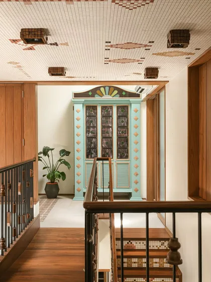 This custom bar cabinet was designed as a centerpiece for a landing. Inspired by Chettinad architecture, it features stained glass panels and a playful colour palette of mint green and ochre, making it a joyful and nostalgic statement piece.