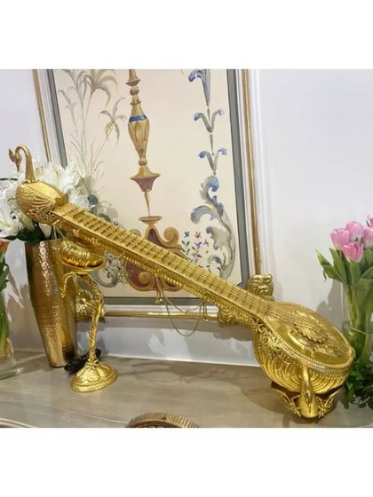 A beautiful golden sitar, an artifact from our Hyderabad event, symbolizing the richness of our musical tradition.