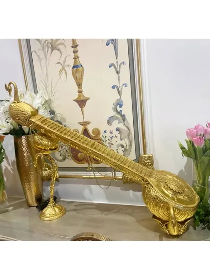 A beautiful golden sitar, an artifact from our Hyderabad event, symbolizing the richness of our musical tradition.