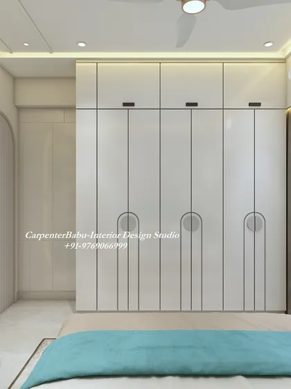 The wardrobe in this bedroom features a clean, minimalist design with unique semi-circular handles, adding a touch of modern geometry.
