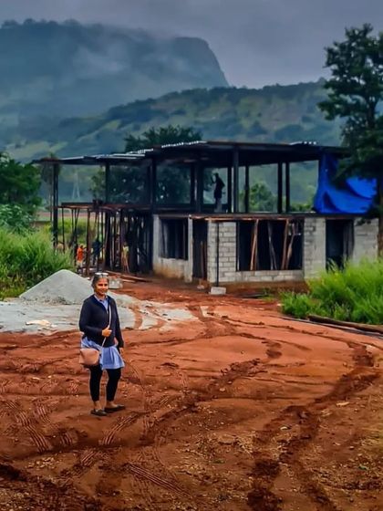 A site visit during the early stages of construction. Standing on the red earth, with the skeletal frame of the house behind me and the misty hills in the distance, is a moment of profound connection to the entire process of creation.