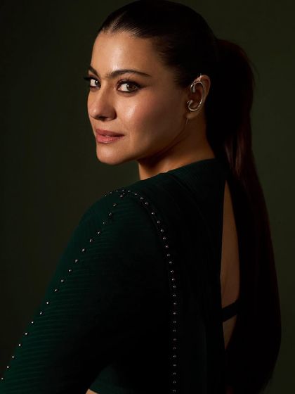 This angle highlights the unique ear cuff and the sleek ponytail, adding a contemporary edge to the red carpet look.