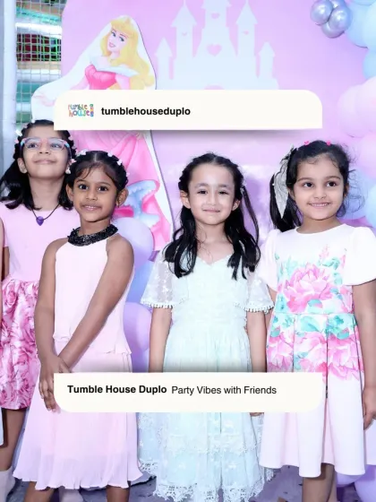 Party vibes with friends! A group of young girls dressed in their party best, smiling for a photo in front of a princess backdrop.